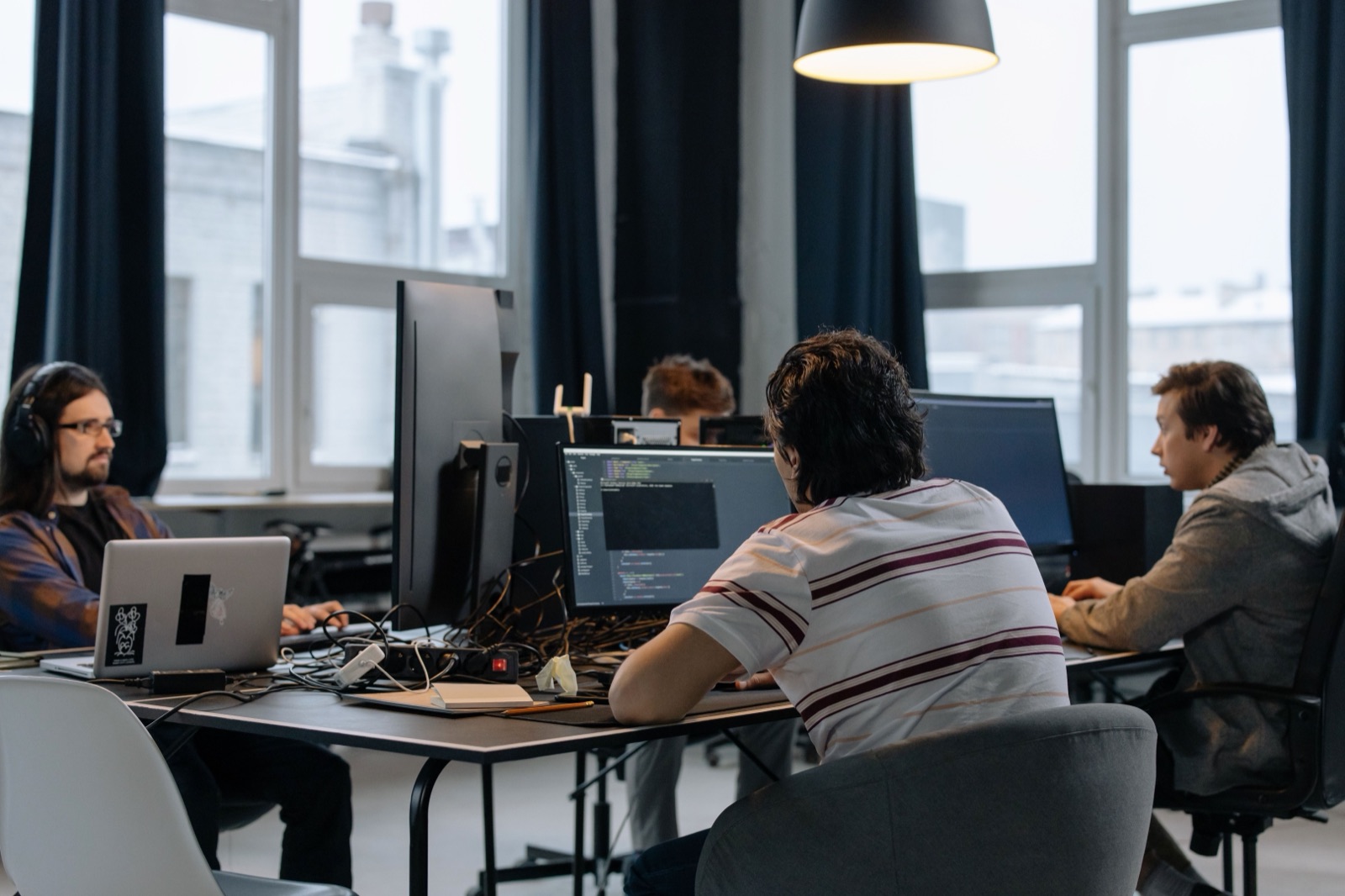A small team working together at shared desks in a bright office